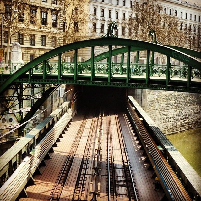 architecture, built structure, building exterior, city, transportation, building, the way forward, modern, diminishing perspective, railroad track, high angle view, city life, railing, low angle view, rail transportation, skyscraper, day, public transportation, office building, incidental people