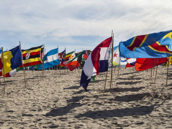 Multi colored umbrellas on beach against sky