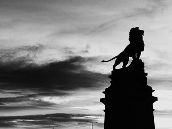 Low angle view of statue against cloudy sky