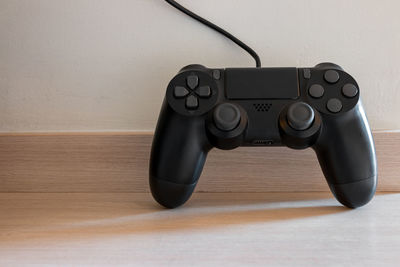 Close-up of telephone on gaming joystick on table