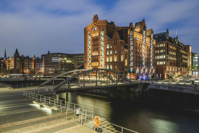 Germany, hamburg, bridge over canal in speicherstadt district at dusk