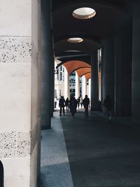 Distance shot of people walking in corridor