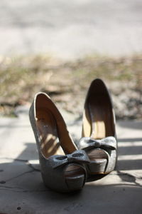 Close-up of stilettos on footpath