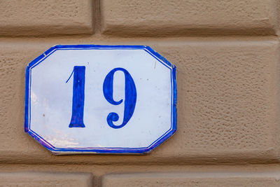 Close-up of number 19 on brick wall