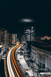 High angle view of light trails on road in city at night