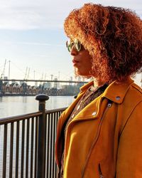 Portrait of woman wearing sunglasses against sea