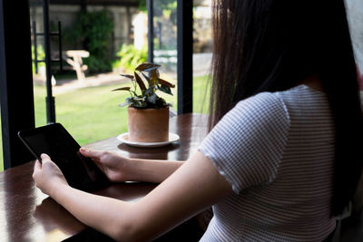 Midsection of woman using mobile phone