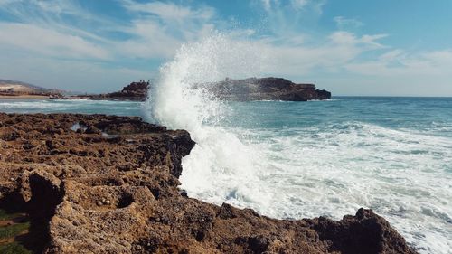 Waves breaking against sea