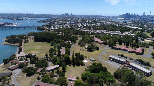 High angle view of city by sea against sky