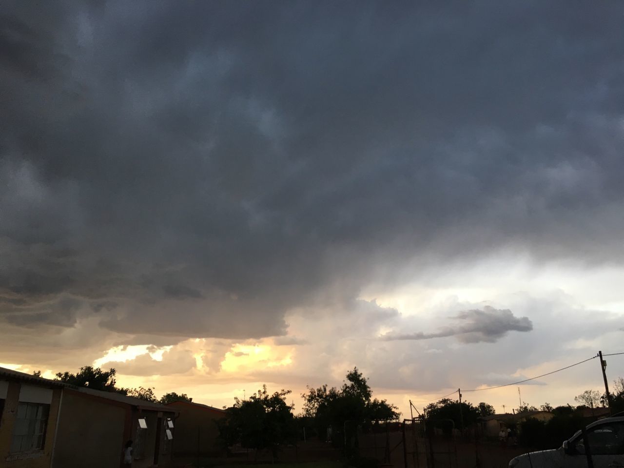 sky, cloud - sky, sunset, cloudy, car, tree, land vehicle, silhouette, transportation, beauty in nature, cloud, weather, nature, building exterior, scenics, overcast, built structure, dramatic sky, architecture, mode of transport