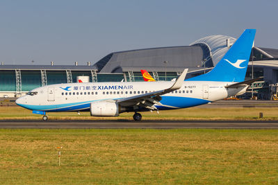 Airplane on airport runway against clear sky