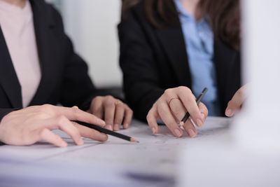 Midsection of business colleagues working at office