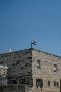 Low angle view of building against clear blue sky