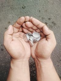 High angle view of human hand holding ring