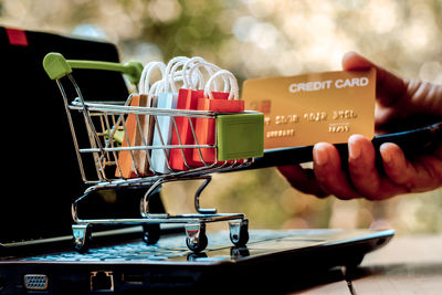 Close-up of hand holding objects in store