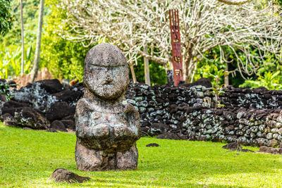 Statue against stone wall