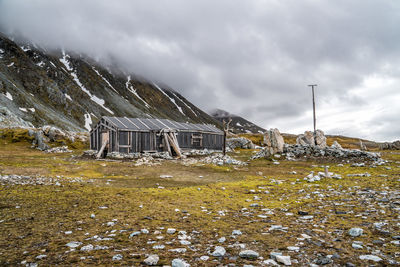 Built structure on field against sky during winter