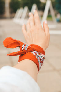 Hand of millennial hipster woman with red bandana scarf. retro style. old fashioned accessories