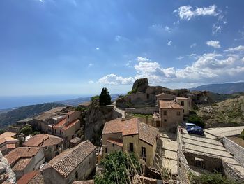 High angle view of townscape by sea against sky