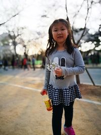 Portrait of smiling girl standing in water