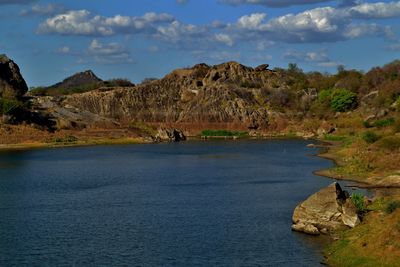 Scenic view of lake and mountains against sky