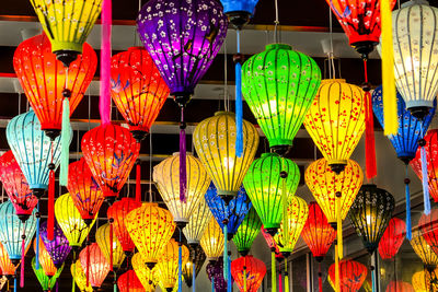 Low angle view of illuminated lanterns hanging in market at night