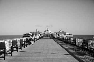 Pier over sea against clear sky