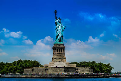 Low angle view of statue against cloudy sky