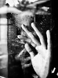 Close-up of hand on wet glass