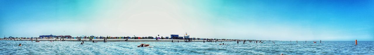 People on beach against sky