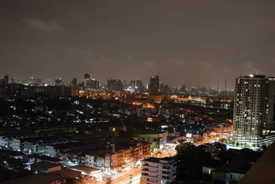 High angle view of illuminated city buildings against sky