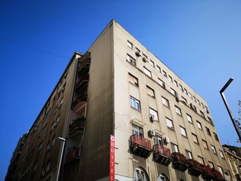 Low angle view of building against clear blue sky