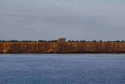 Scenic view of sea and buildings against sky