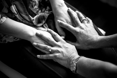 Close-up of couple touching hands