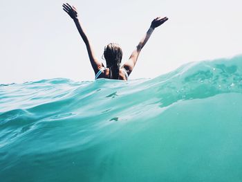 Portrait of young woman swimming in sea