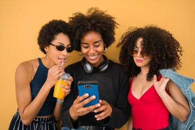 Happy young woman using mobile phone