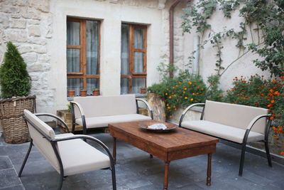 Chairs and table against window of house