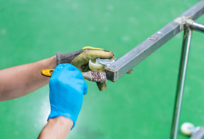 Cropped image of man holding equipment