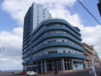 Low angle view of building against cloudy sky