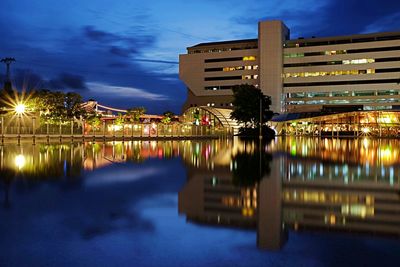 Reflection of buildings in lake at night