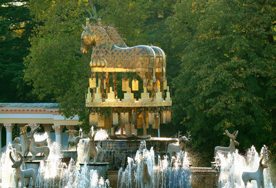 Statue of fountain against plants