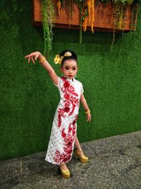 Girl in traditional clothes posing outdoors