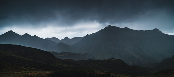 Scenic view of silhouette mountains against sky