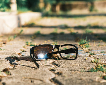 Close-up of sunglasses on field