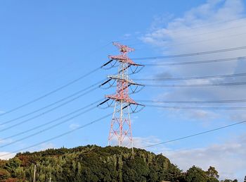 Low angle view of electricity pylon against sky