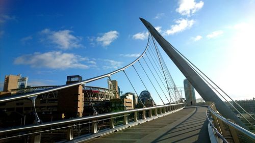 Bridge over river against cloudy sky