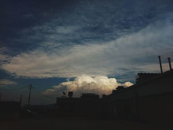 Smoke emitting from chimney against sky