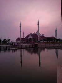 Reflection of building in lake at sunset