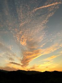 Scenic view of silhouette mountains against sky at sunset