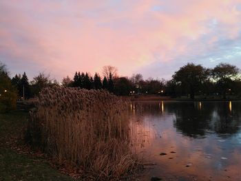 Scenic view of lake against sky at sunset